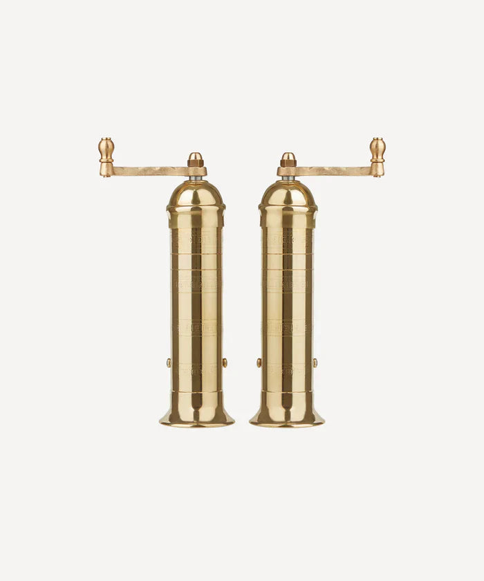 This is a picture of a set of handmade Brass salt & pepper mills from Greece, with a top handle standing side by side.
