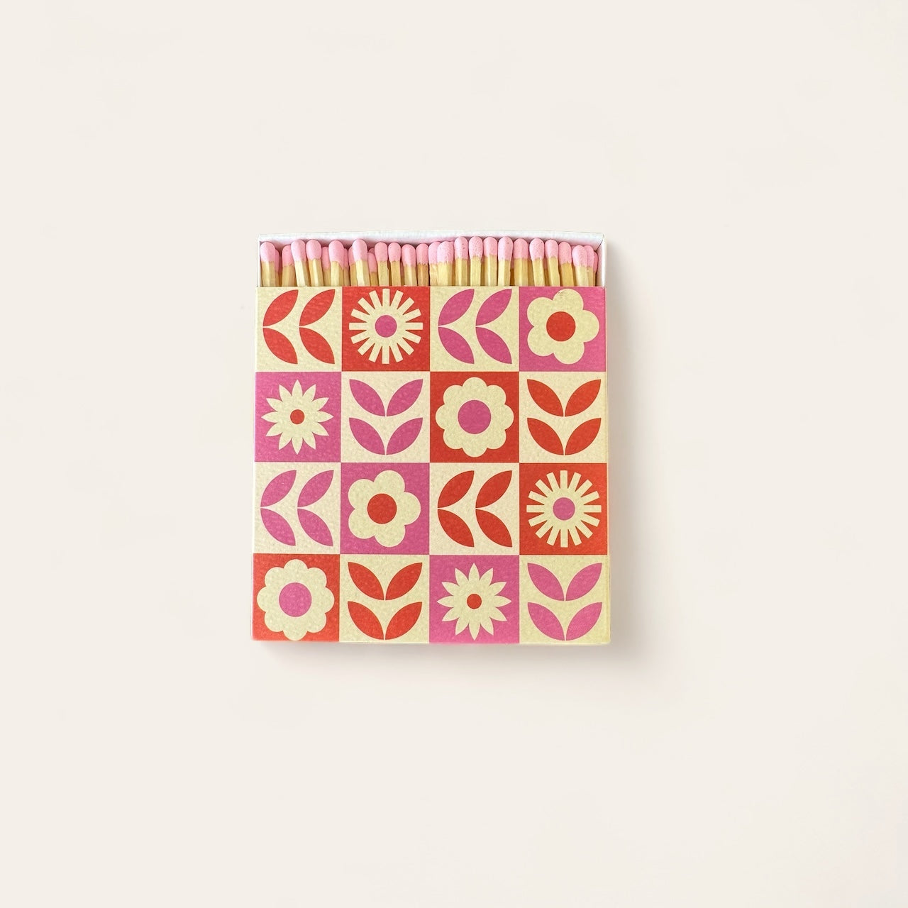 A box of luxury large matches with a pink matchhead in a pink and orange floral patterned box.