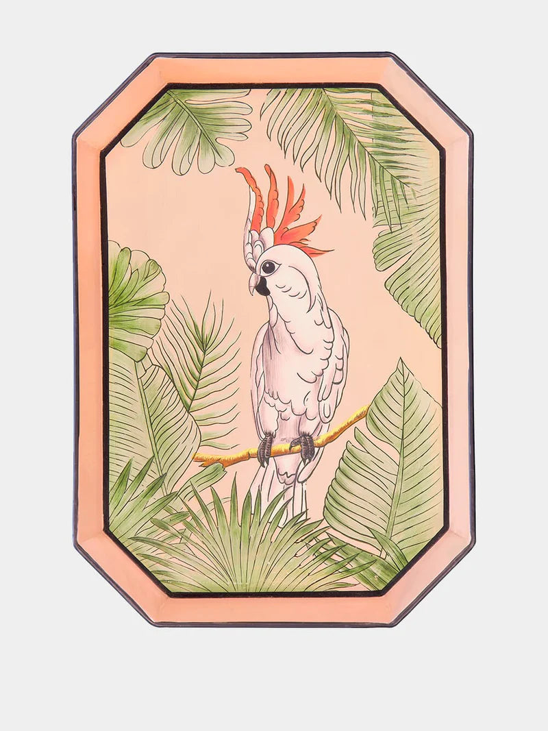 A rectangular shaped iron tray that features a hand-painted illustration of a Pink Cockatoo surrounded by tropical leaves on a peach coloured background.