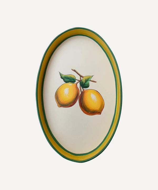 An oval shaped iron tray that features a hand-painted illustration of Lemons on a cream background with a yellow and green border.