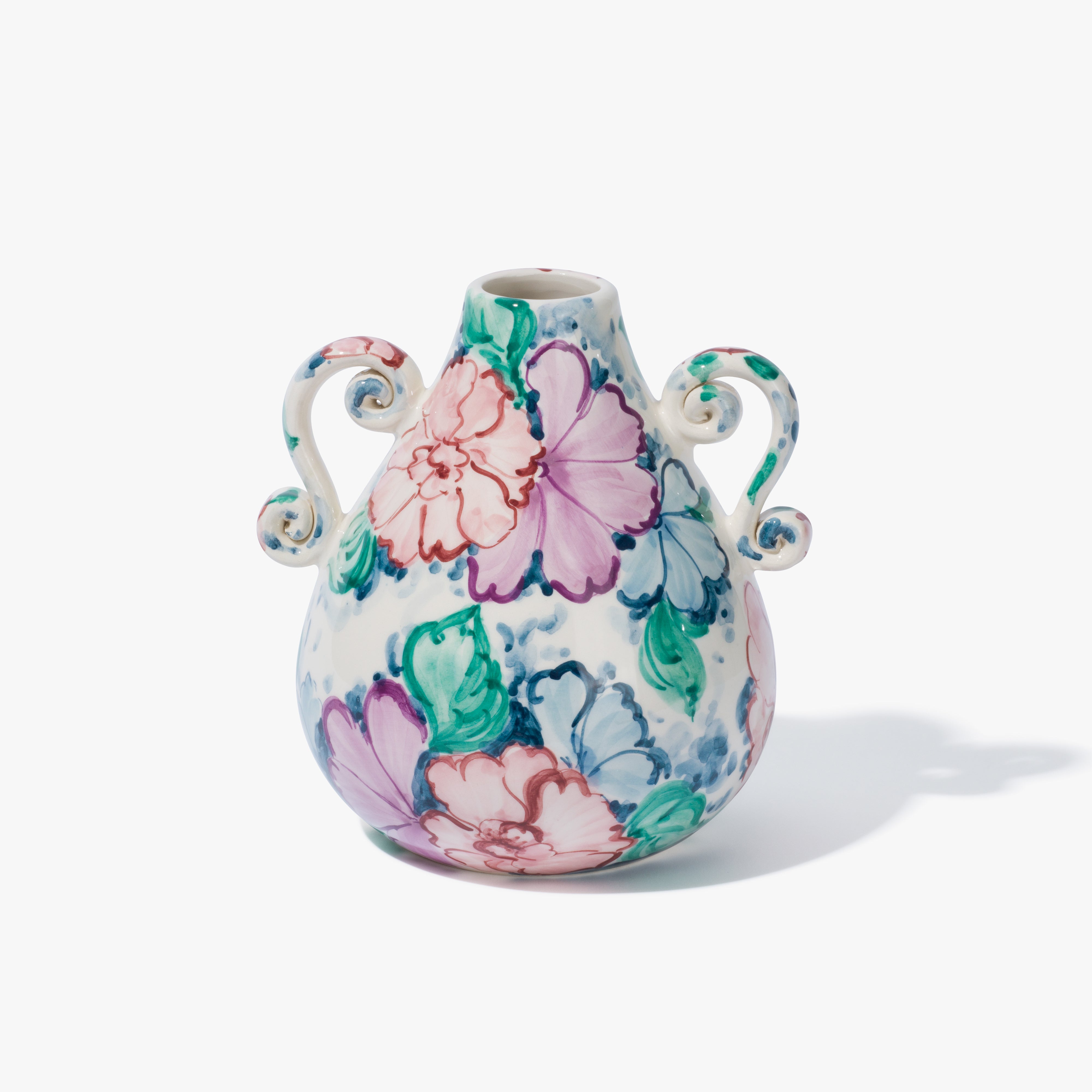 A handpainted floral vase in a beautifully sculptured shape with two handles. The pattern is a combination of blue, green, pink and purple.