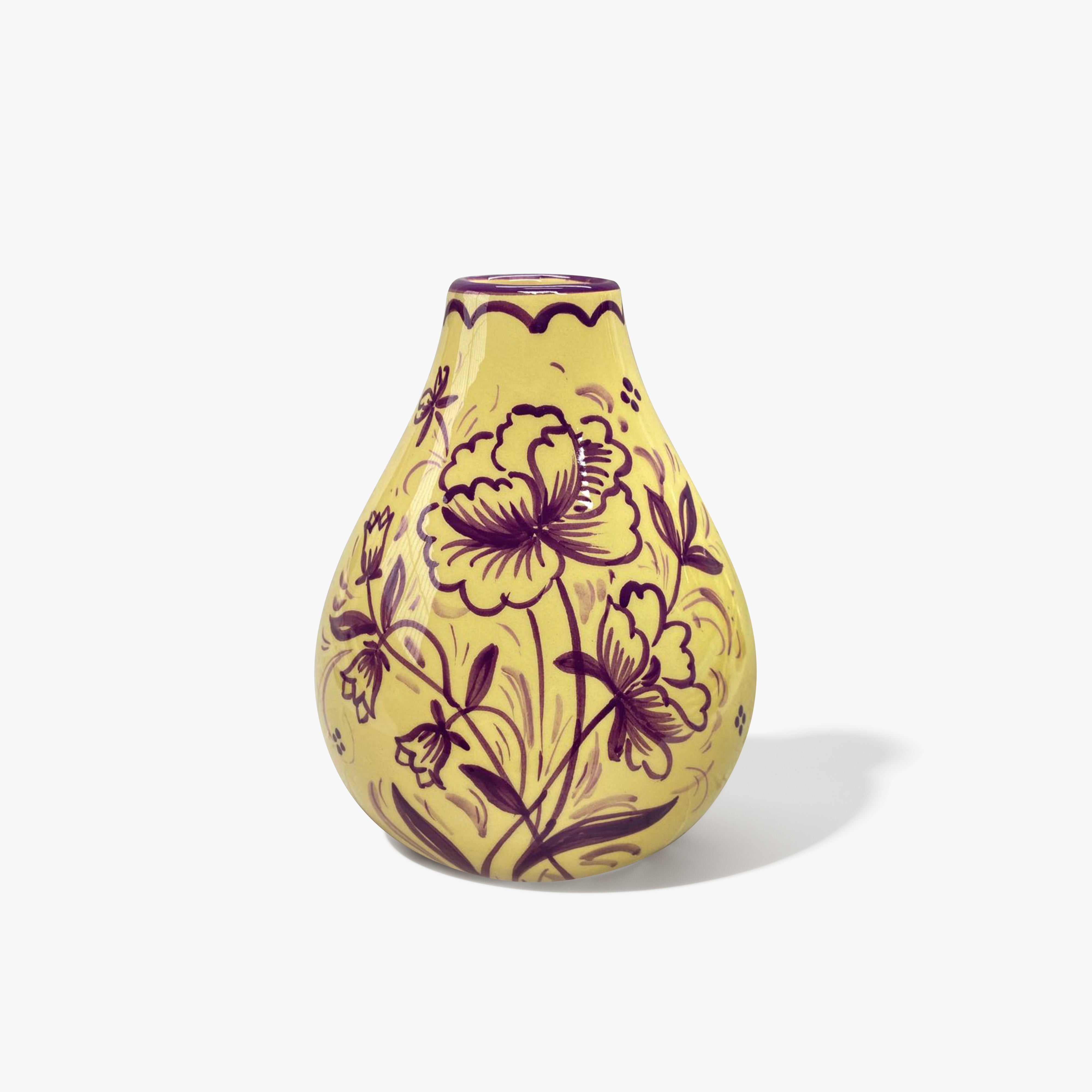 A baby yellow vase in a bulb shape with a purple floral patten.