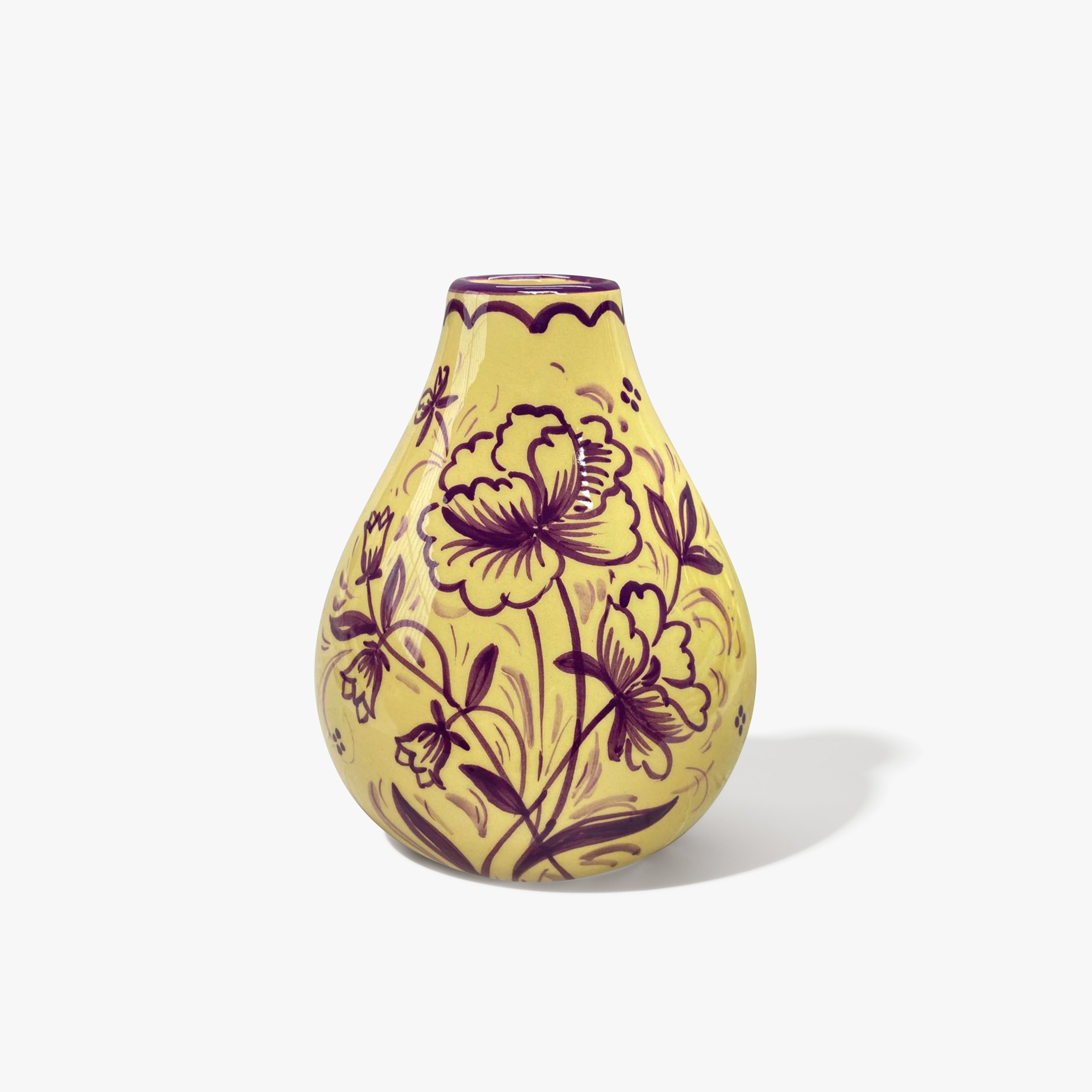 A baby yellow vase in a bulb shape with a purple floral patten. 